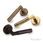Hammered Bauhaus Door Handle on Round Rose in Polished Brass