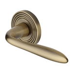 Sutton Reeded Door Handle on Round Rose in Antique Brass