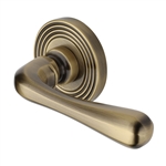 Charlbury Reeded Door Handle on Round Rose in Antique Brass