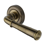 Colonial Reeded Door Handle on Round Rose in Antique Brass