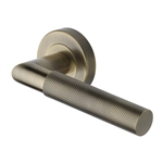 Bauhaus Mitre Knurled Door Handle on Round Rose in Antique Brass